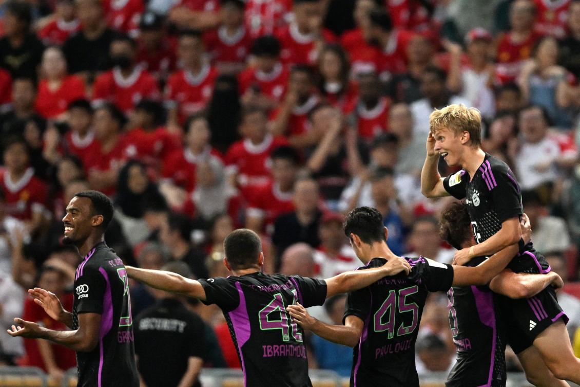 Bayern Munich’s Frans Kratzig (R) celebrates after scoring a goal against Liverpool during their Singapore Festival of Football pre-season friendly match in Singapore on August 2, 2023. (AFP)