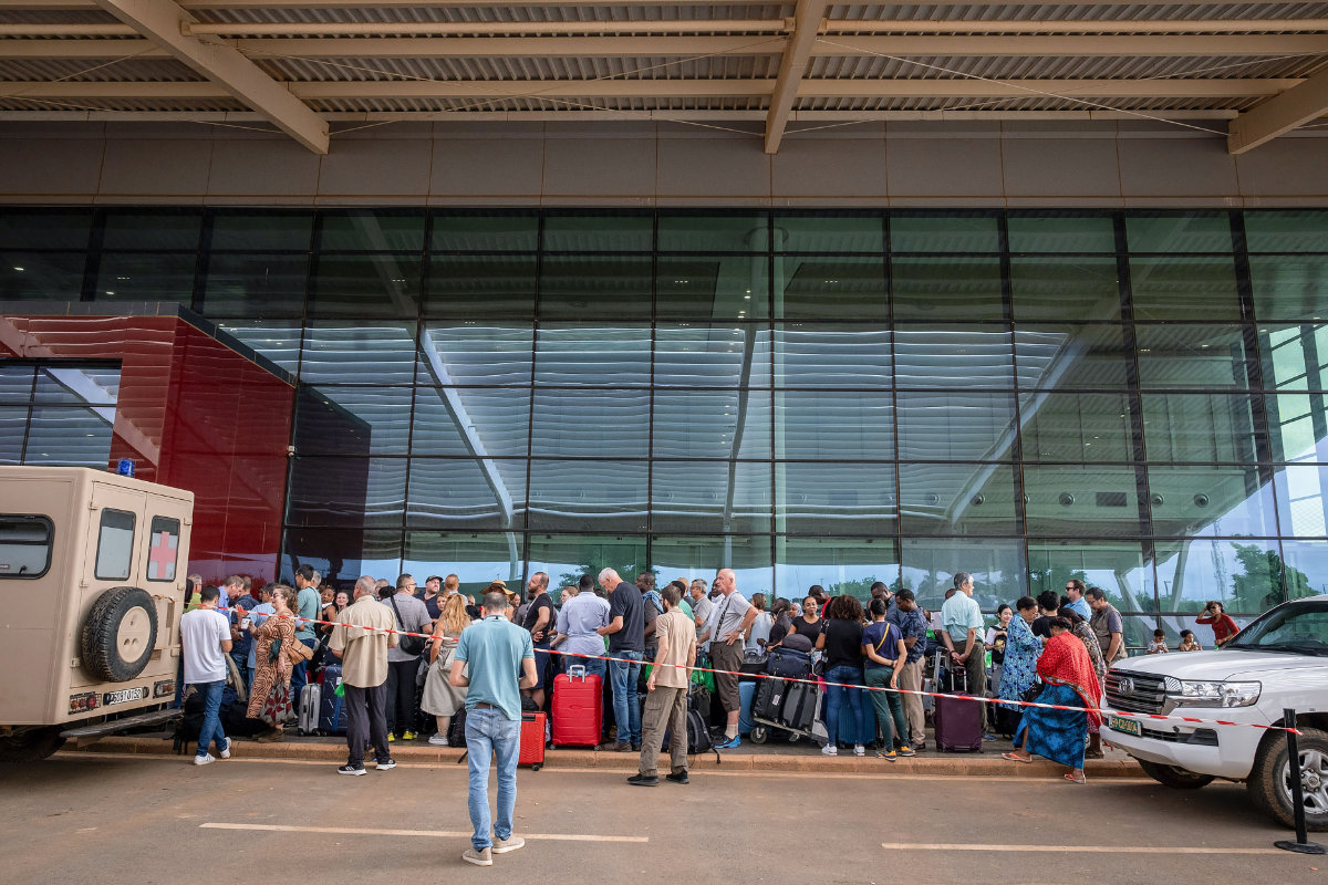 Passengers queue outside Diori Hamani international airport in Niamey, Niger, on August 2, 2023, as part of the third evacuation a week after a coup toppled one of the last pro-Western leaders in the jihadist-plagued Sahel. (French government handout via AFP)