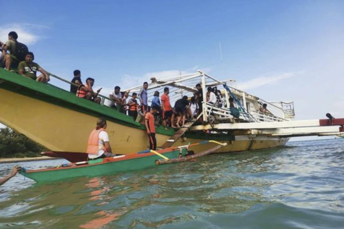 Rescued passengers arrive on a boat in Polillo, Quezon province, northeastern Philippines on Aug. 3, 2023. (Philippine Coast Guard via AP)