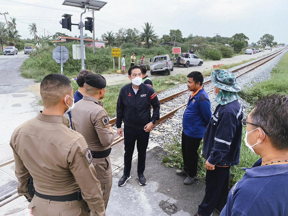Thai rail officials talk with police authorities at the crash site in Muang of Chachoengsao province on Aug. 4, 2023. (State Railway of Thailand via AP)