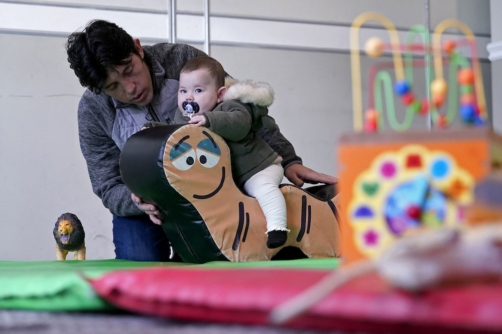 Above, Afghan refugees play in a playroom of a hotel in Leeds, northern England on Nov. 30, 2021 which is being used to accommodate them. (AFP)