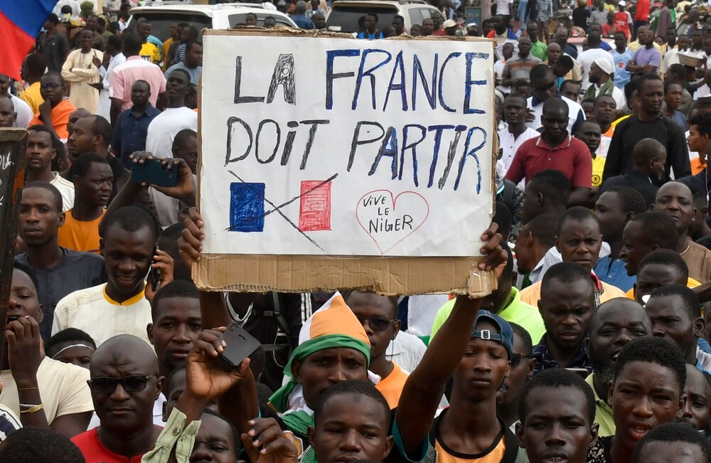 Protesters hold an anti-France placard during a demonstration on independence day in Niamey on August 3, 2023. (AFP)