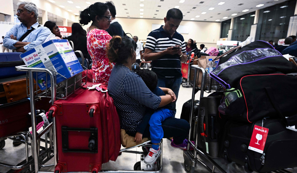 Passengers wait inside the arrival hall at Bandaranaike International Airport in Katunayake. (AFP file photo)