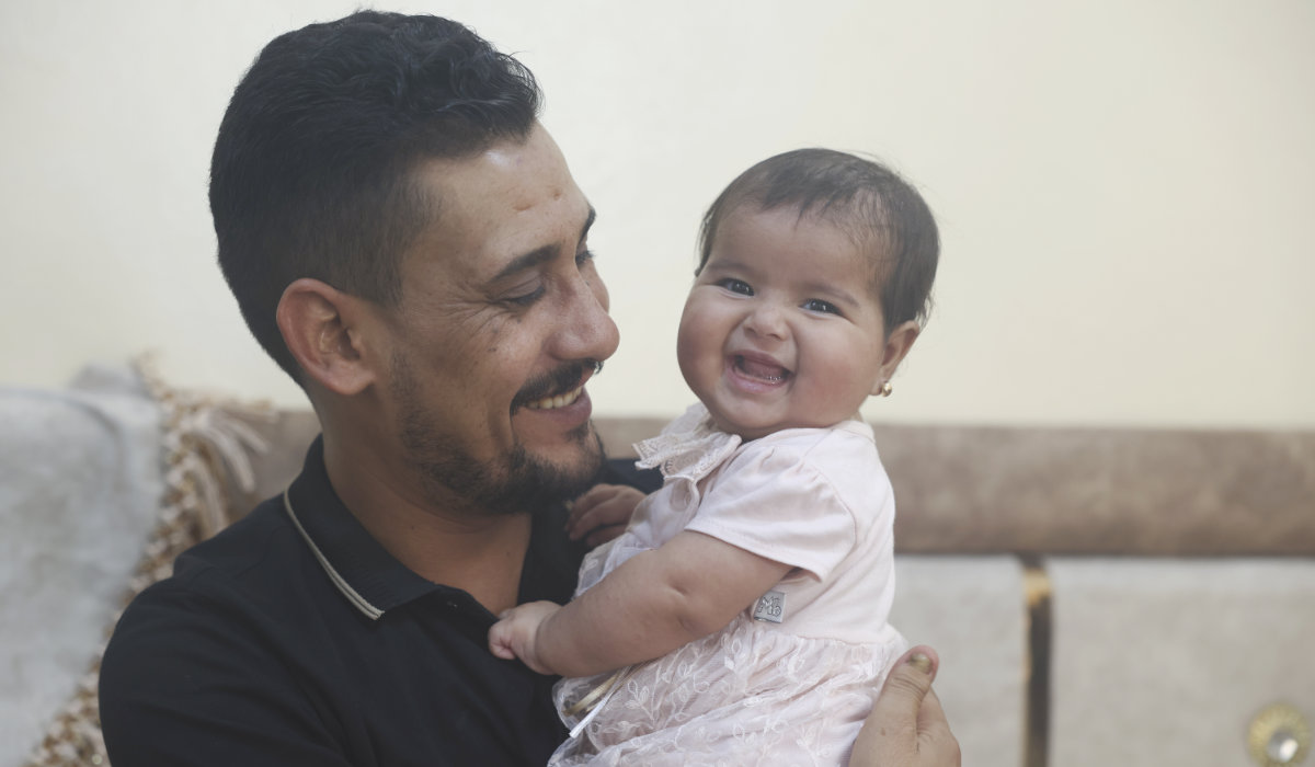 Khalil al-Sawadi plays with his adopted daughter Afraa in Jinderis, Syria, on Saturday, Aug. 5, 2023. (AP)