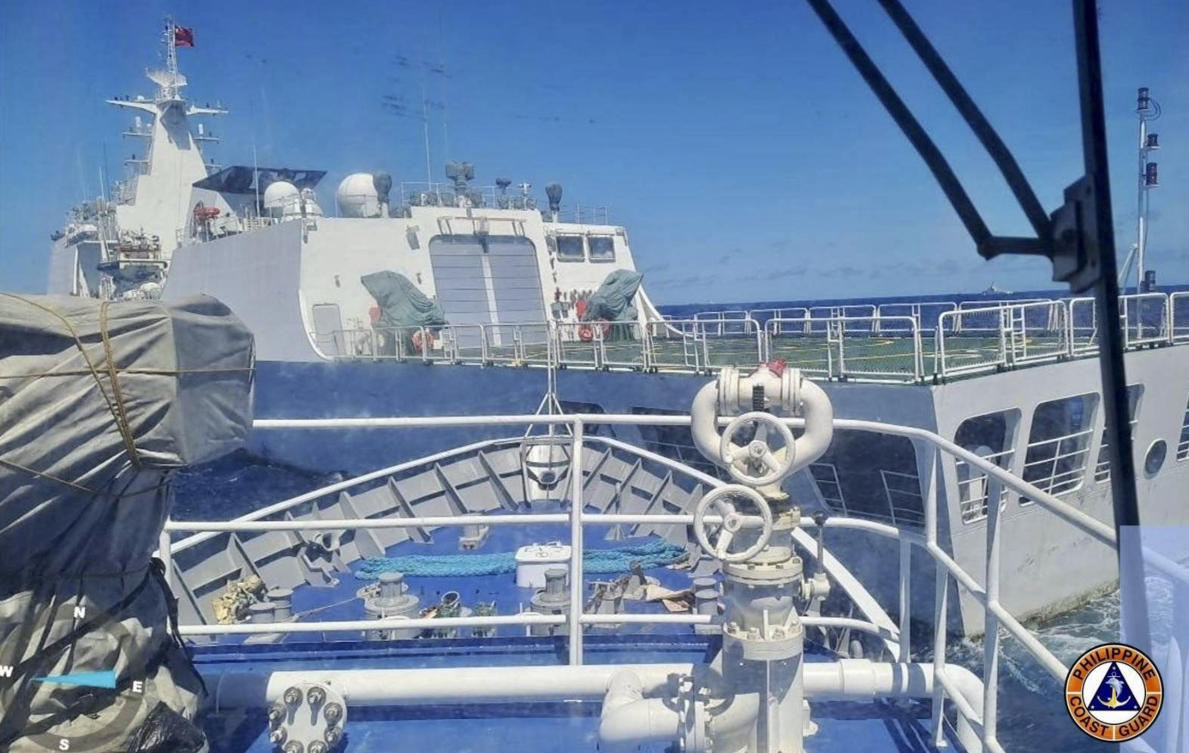 A Chinese Coast Guard ship, front, blocks the path of a Philippine Coast Guard ship near the Philippine-occupied Second Thomas Shoal, South China Sea during a re-supply mission on Saturday Aug. 5, 2023. (Philippine Coast Guard via AP)