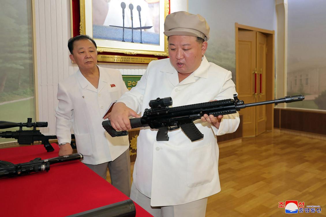 North Korean leader Kim Jong Un inspects a new series of firearm during a visit to a major munitions factory at an undisclosed location in North Korea. (KCNA via KNS/AFP)