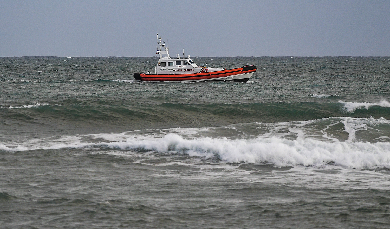 A boat of the Italian Coat Guards patrols off the beach on February 26, 2023 in Steccato di Cutro, south of Crotone, where debris of a shipwreck were washed ashore after a migrants' boat sank off Italy's southern Calabria region. (AFP/File)