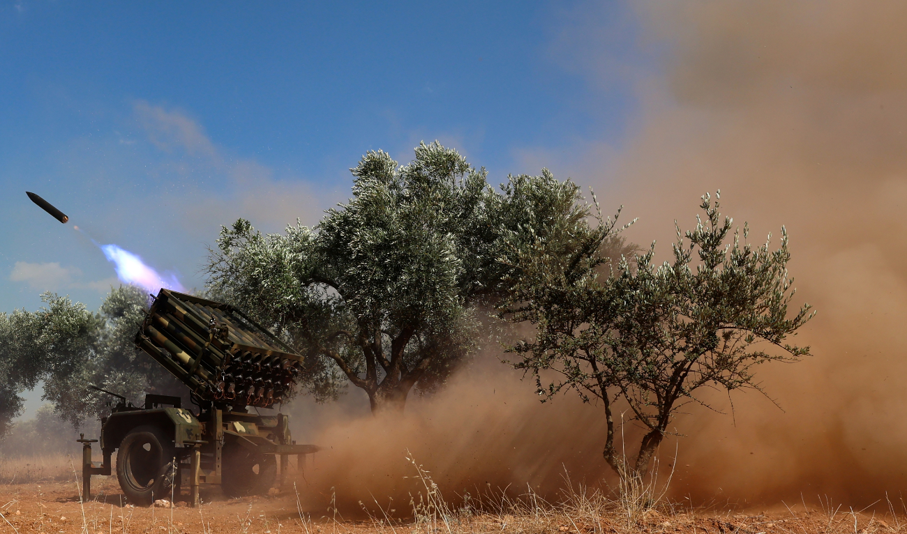 A rocket is fired from a multi-barrel launcher from a position held by the Hayat Tahrir Al-Sham (HTS) group in Syria’s northwestern Idlib province, toward Syrian regime forces, on June 21, 2023. (AFP/File)