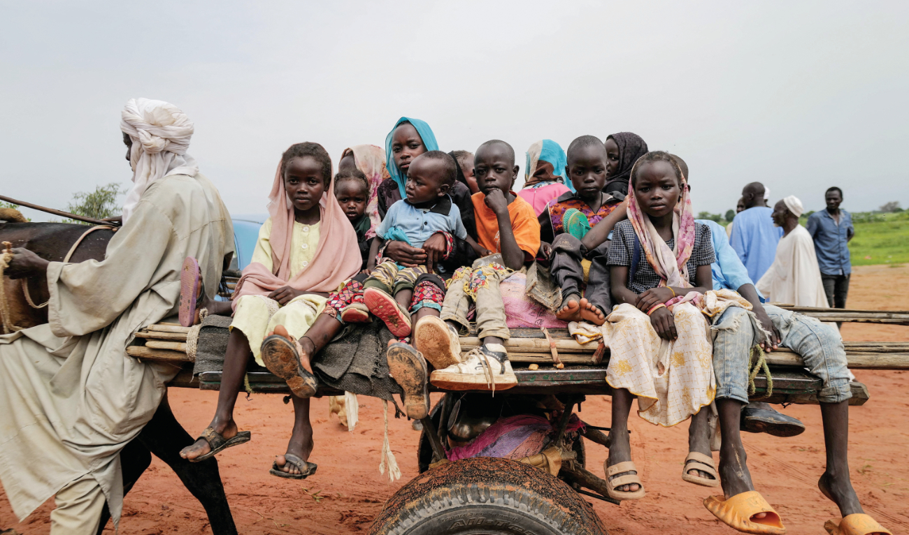 Sudanese children, who fled the conflict, ride a cart while crossing the border between Sudan and Chad. A ministerial meeting on Sudan crisis is being held in Chad. (Reuters)