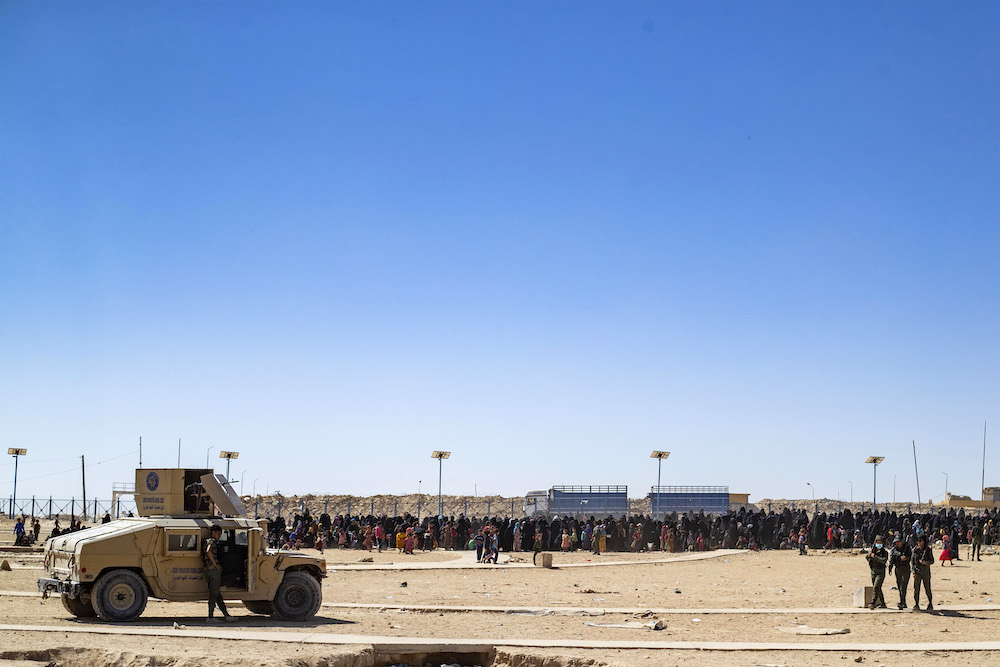 Members of the Syrian Kurdish Asayish security forces stand guard during an inspection at the Kurdish-run Al-Hol camp in the northeastern Hasakeh governorate on Aug. 28, 2022. (AFP)
