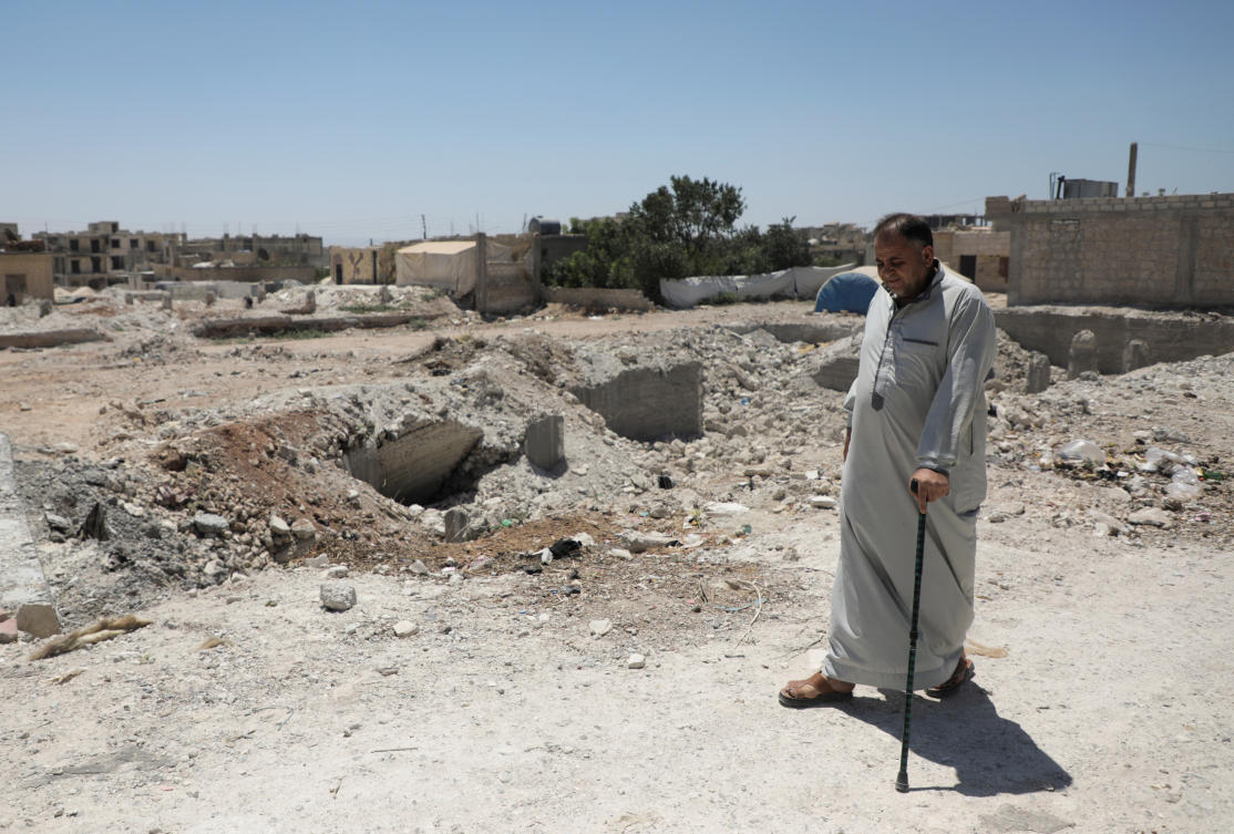 Syrian quake survivor, Habib Gharib Habib, walks past rubble of damaged buildings in Jandaris, almost six months after a devastating earthquake, in northern Syria August 4, 2023. (Reuters)