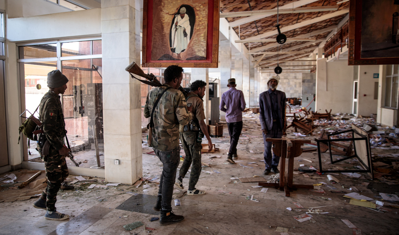 Amhara Fano fighters walk in the ransacked terminal at the Lalibela airport in Lalibela, on December 7, 2021. (AFP/File)