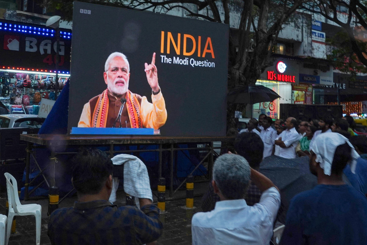 People watch the BBC documentary "India: The Modi Question", on a screen installed at the Marine Drive junction under the direction of the district Congress committee, in Kochi on January 24, 2023. (AFP)