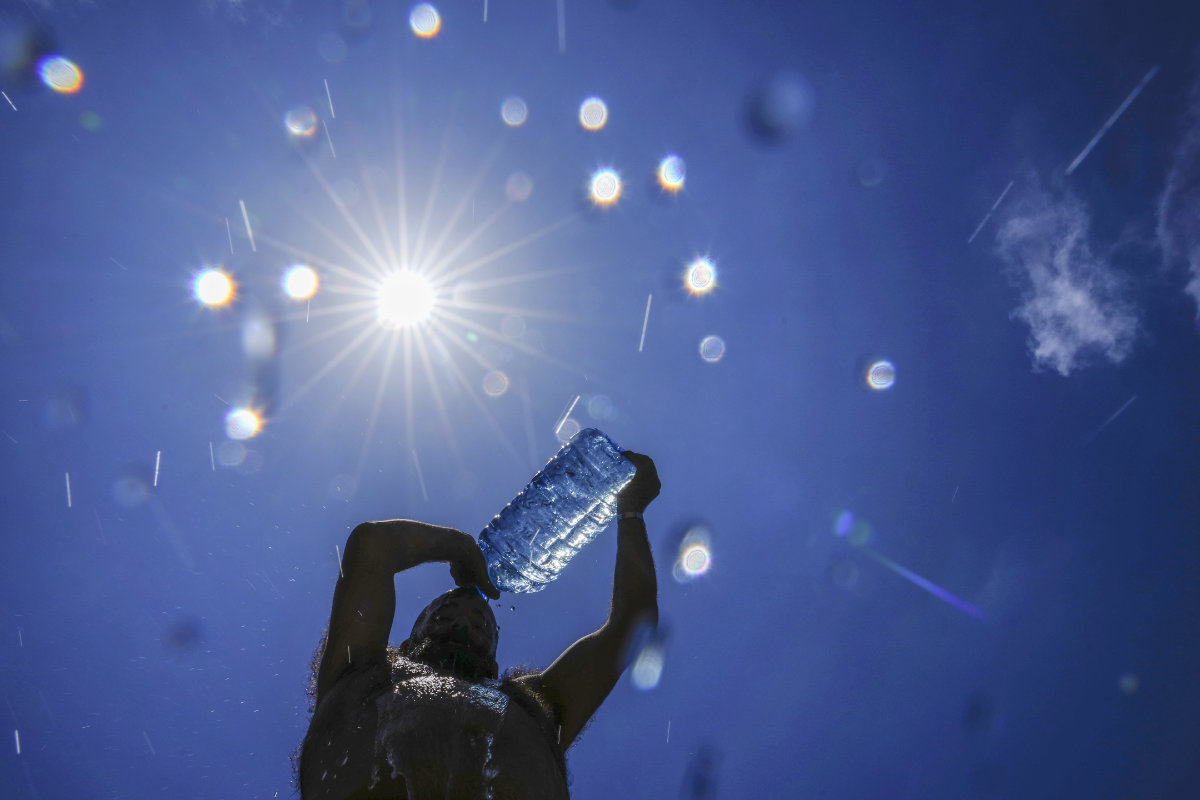 A man pours cold water onto his head to cool off on a sweltering hot day in the Mediterranean Sea in Beirut, Lebanon, July 16, 2023. (AP)