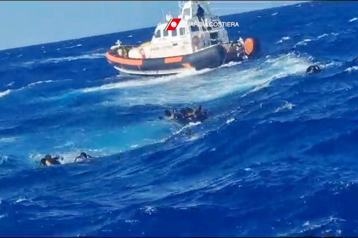 This handout photograph taken on August 5, 2023 by Italian Coastguard (Guardia Costeria) and released on August 6, 2023, shows a rescue operation that took place south of Lampedusa, consisting in rescuing 57 migrants, also recovering the lifeless bodies of a woman and a minor on board. (AFP)