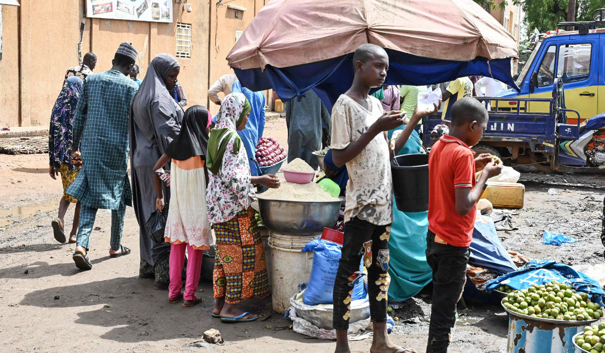 Customers buy goods at a market in Niamey on August 8, 2023. (AFP)