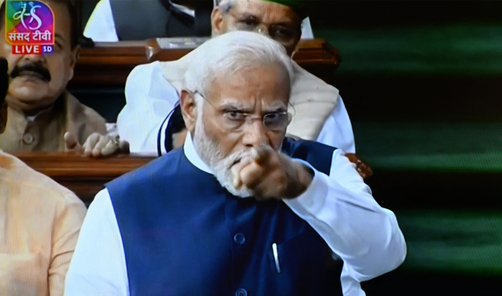 In this screen grab India's Prime Minister Narendra Modi (R) is seen on a television screen as he addresses the lower house Lok Sabha in New Delhi on August 10, 2023, in response to the Opposition's no-confidence motion against the NDA government. (AFP)