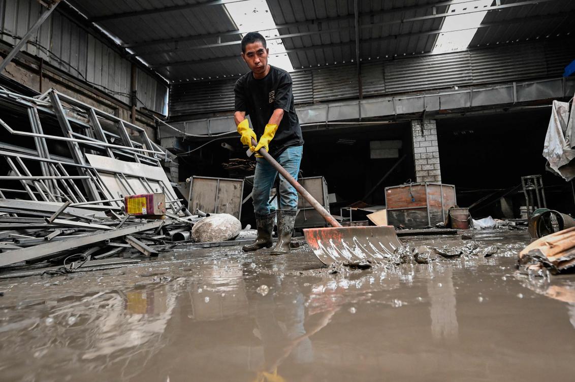 Heavy rains are expected again over the weekend as tropical depression Khanun — formerly a typhoon — approaches China. (AFP)