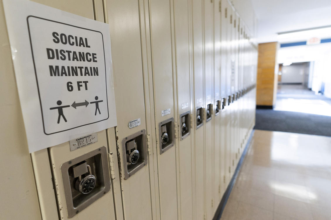 Several countries in the Northern Hemisphere, including the United States, United Kingdom, France and Japan have seen a summer uptick in cases in recent weeks. Above, a social distancing sign posted on student lockers at a school in Baldwin, New York on Aug. 28, 2020. (AP)