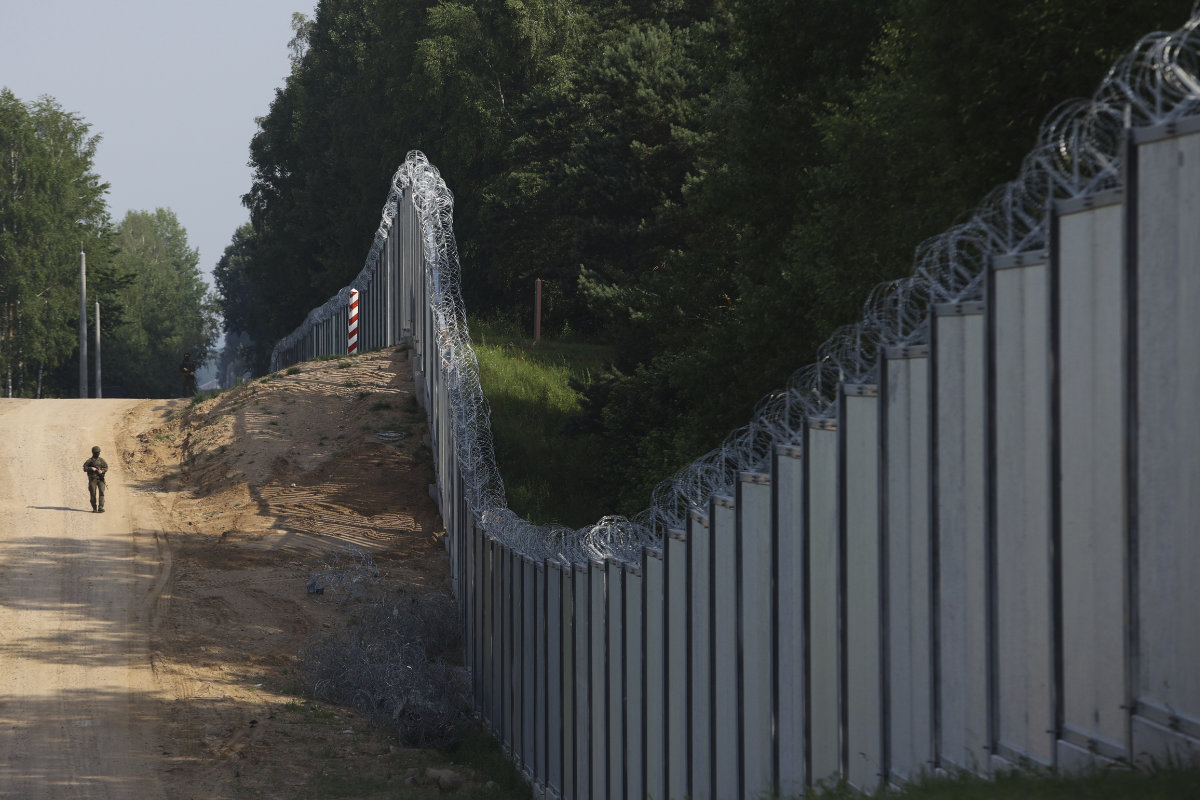 This photo taken on June 30, 2022, shows a Polish border guard along the border between Poland and Belarus near Kuznice, Poland. Poland says it is sending 10,000 troops to beef up its border force as Warsaw worries about migrants and Russian-linked mercenaries coming across its border. (AP/file)