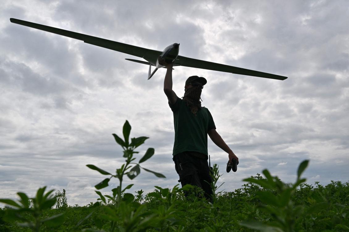 Drone attacks on Russian-controlled territories in Ukraine and deep inside Russia have increased since a drone was destroyed over the Kremlin in early May. Above, an operator carries a reusable airstrike drone made by the Ukrainian company UA Dynamics during a test in Kyiv on Aug. 11, 2023. (AFP)