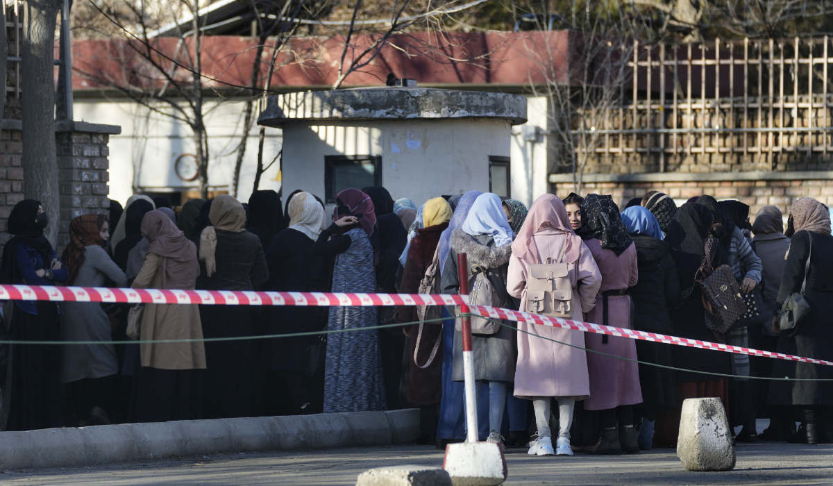 Afghan students queue at one of Kabul University's gates in Kabul, Afghanistan, on Feb. 26, 2022. (AP)