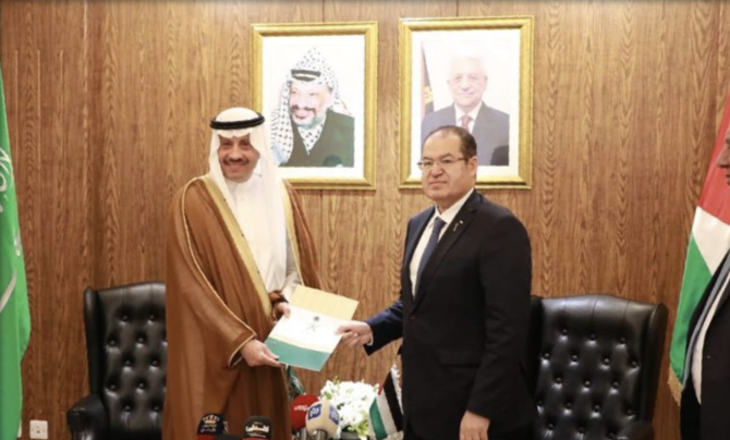 Non-resident ambassador for the Palestinian Territories Naif bin Bandar Al-Sudairi presents his credentials to Majdi Al-Khalidi, diplomatic affairs advisor to the Palestinian president, at the headquarters of the Palestinian embassy in Amman, Jordan. (Twitter: @KSAMOFA)