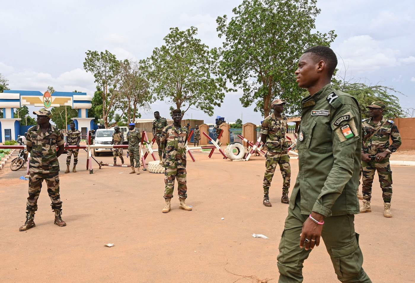 Nigerien soldiers stand guard as supporters of Niger’s National Council for the Safeguard of the Homeland (CNSP) gather for a demonstration in Niamey. (AFP)