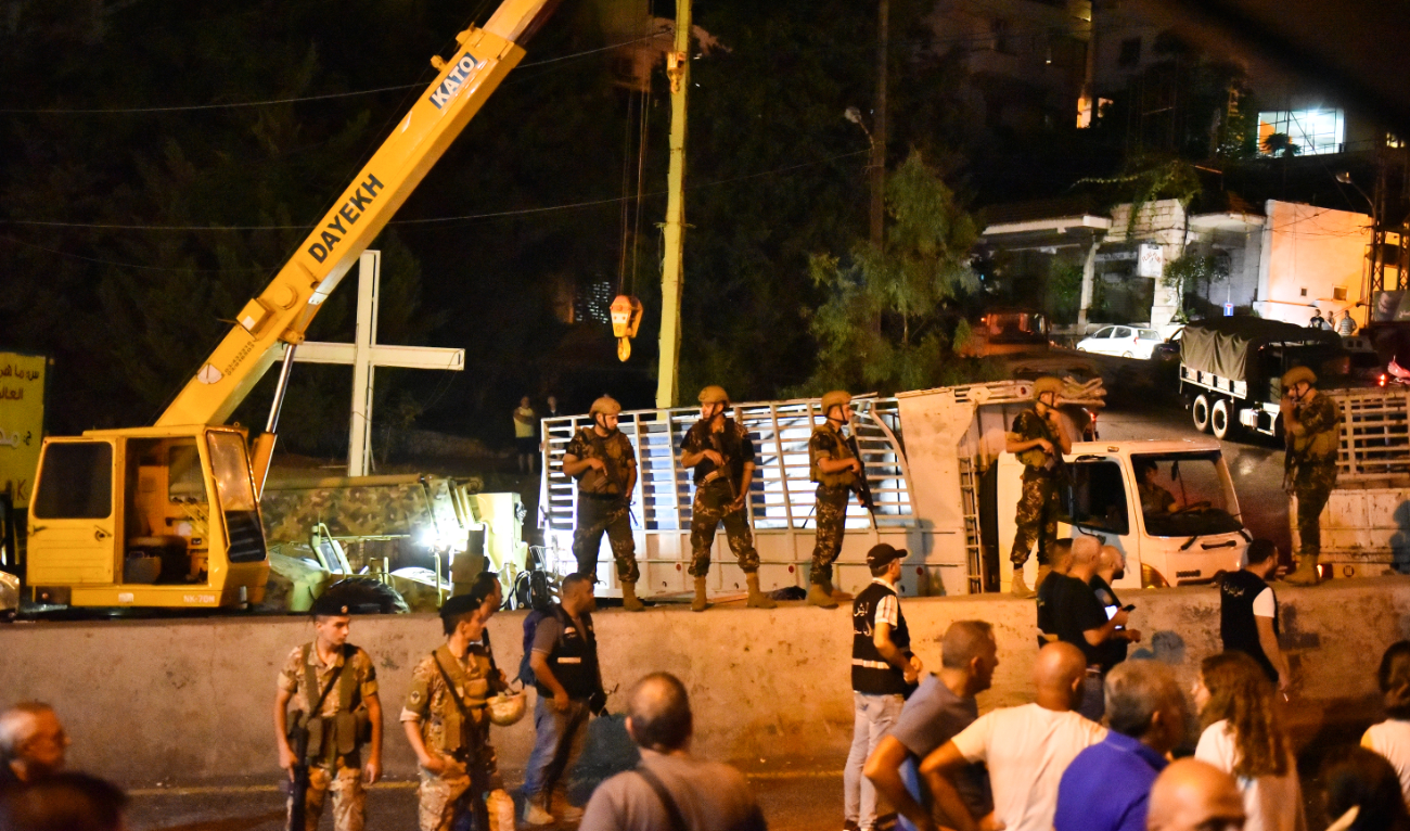 Lebanese army soldiers and onlookers gather in the town of Kahale, where two people were killed in clashes between members of Hezbollah group and residents of the Christian town on August 9, 2023. (AFP/File)