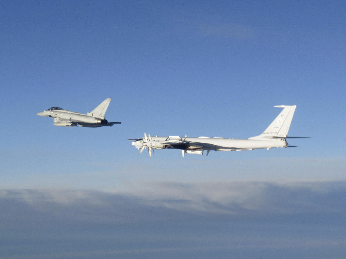  A British Royal Air Force Typhoon, left, monitors a Russian Tupolev Tu-142 long-range maritime patrol bomber as it transited north of the Shetland Islands within NATO's northern air policing area on Aug. 14, 2023. (UK Ministry of Defense photo via AP)