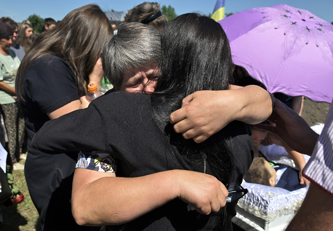 Parents and close relatives mourn during funeral ceremony for 8-year-old boy Volodymyr Balabanyk in the village of Tseniava outside town of Kolomyia, western Ukraine. (File/AFP)