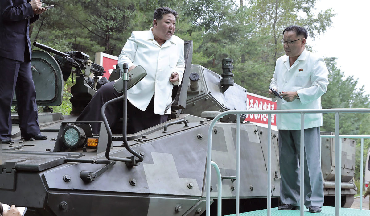 In this undated photo provided on Monday, Aug. 14, 2023, by the North Korean government, North Korean leader Kim Jong Un, center, rides on an armored vehicle during his Aug. 11-12 visit to a military factory in North Korea. (AP)