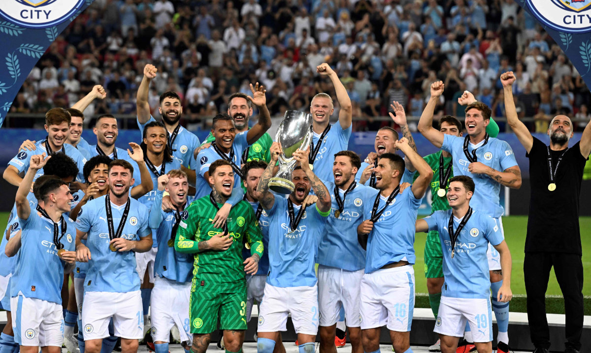 Manchester City's players celebrate on the podium after winning the 2023 UEFA Super Cup football match between Manchester City and Sevilla at the Georgios Karaiskakis Stadium in Piraeus on August 16, 2023. (AFP)