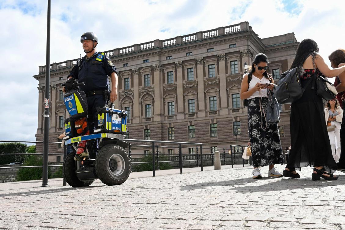 A police officer on a Segway patrols at Sweden’s parliament Riksdagen as the terror threat level in Sweden was raised to four on a five-point scale on Aug. 17, 2023. (AFP)