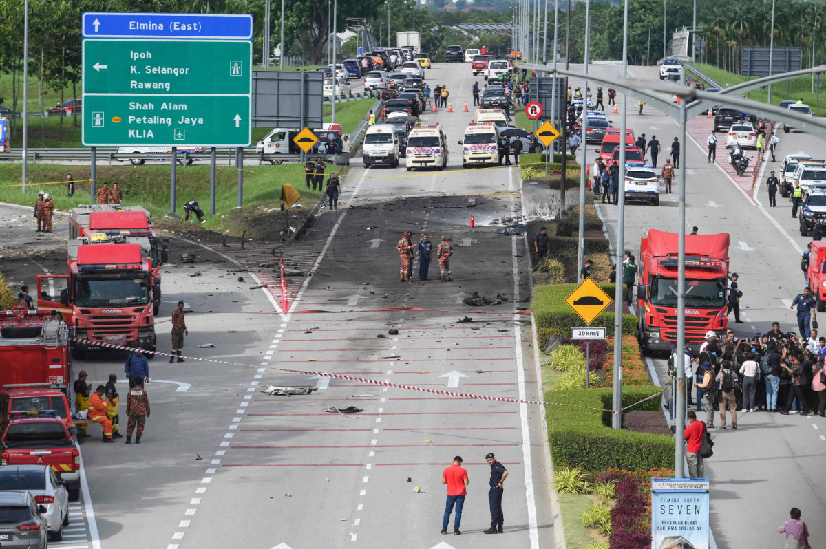 Rescuers inspect the crash site of a plane in Shah Alam, Malaysia's Selangor state on August 17, 2023. (AFP)