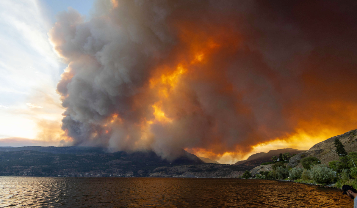 The McDougall Creek wildfire burns in the hills West Kelowna, British Columbia, Canada, on August 17, 2023, as seen from Kelowna. Evacuation orders were put in place for areas near Kelowna, as the fire threatened the city of around 150,000. (AFP)