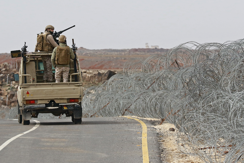 Above, Jordanian army soldiers patrol along the border with Syria to prevent trafficking on Feb. 17, 2022. (AFP)