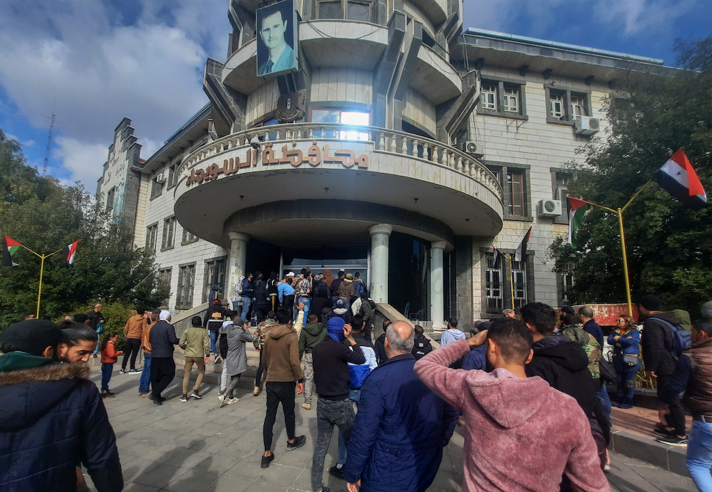 A file photo of demonstrators rallying to protest deteriorating living conditions in front of the Suwaida governorate building in the eponymous southern Syrian city, on December 4, 2022. (AFP)
