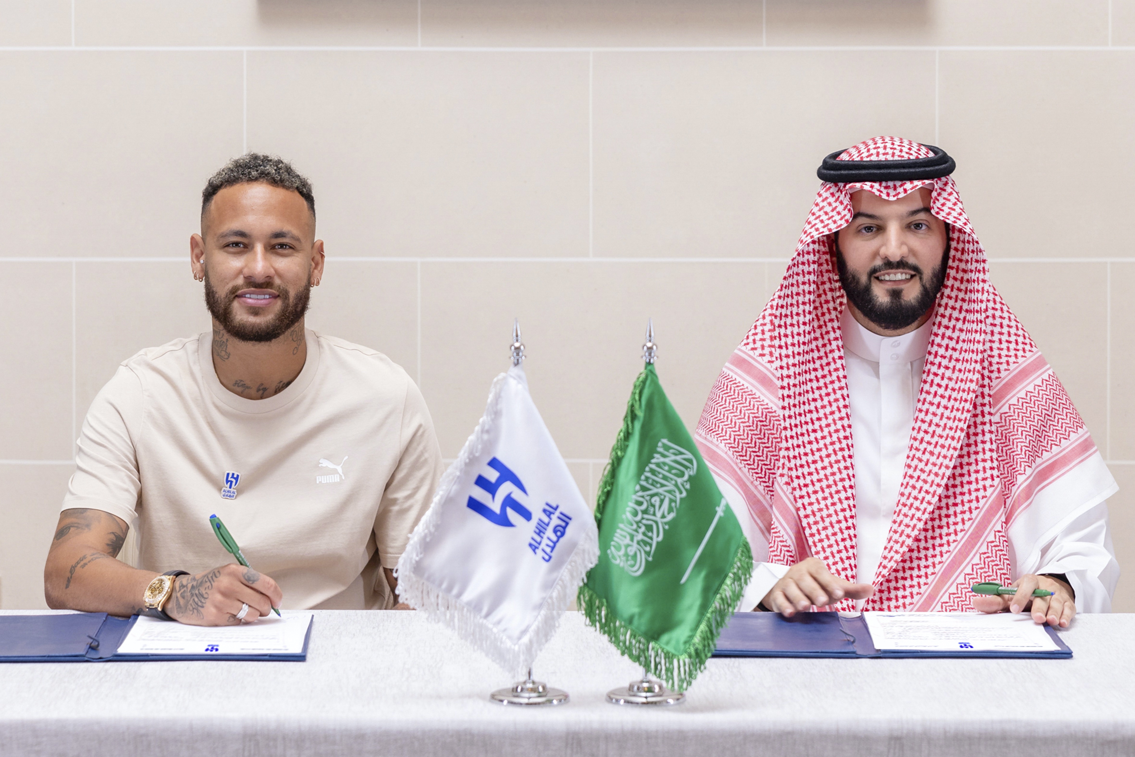 Neymar signs a contract with Chairman of the Board of Directors of Al Hilal, Fahad Bin Saad Bin Nafel, in Paris. AP