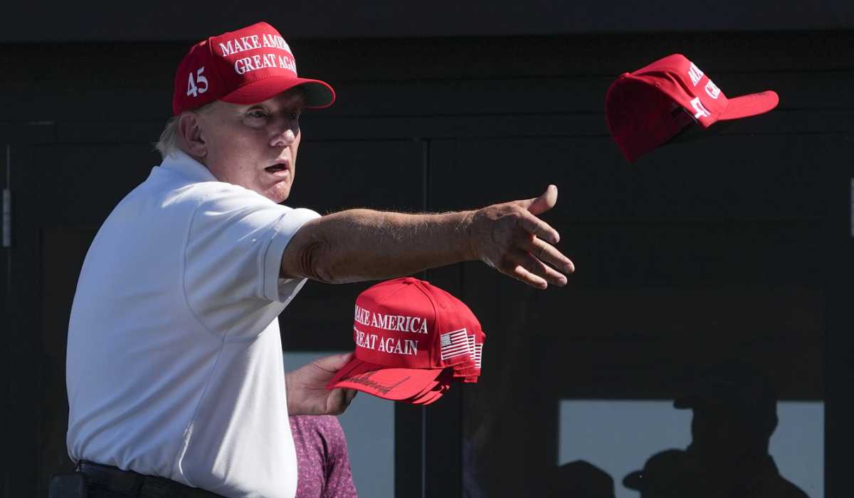 Former President Donald Trump throws autographed red hats to the crowd during the final round of the Bedminster Invitational LIV Golf tournament in Bedminster, N.J., Sunday, Aug. 13, 2023. (AP)