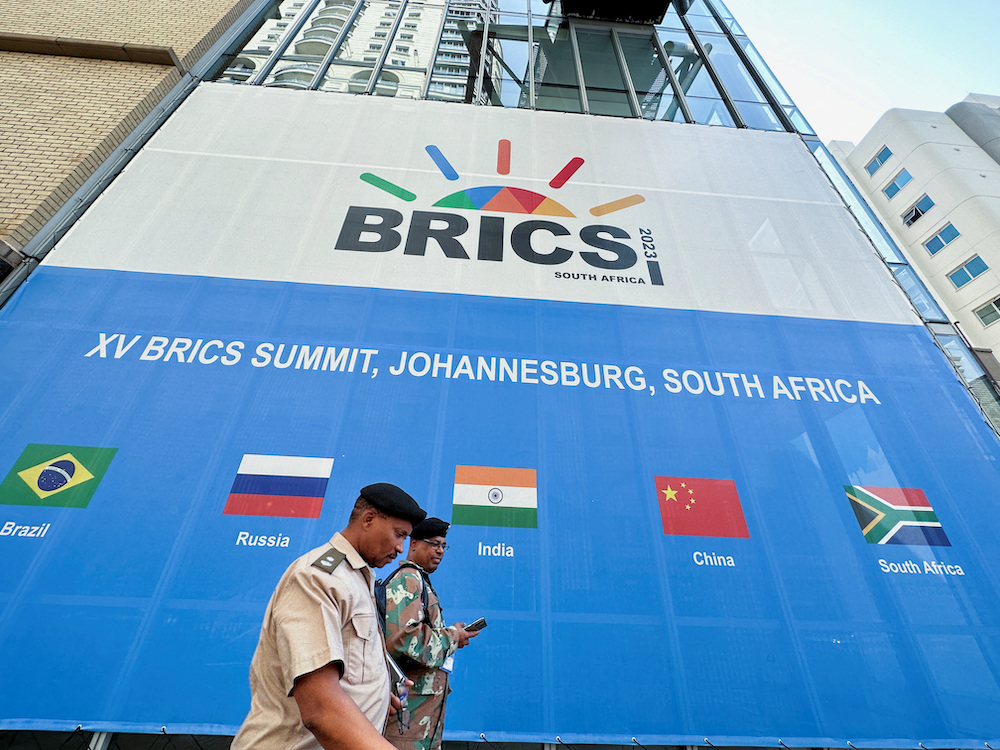 People walk past the Sandton Convention Centre, which will host the upcoming BRICS Summit, in Johannesburg, South Africa August 19, 2023. (REUTERS)