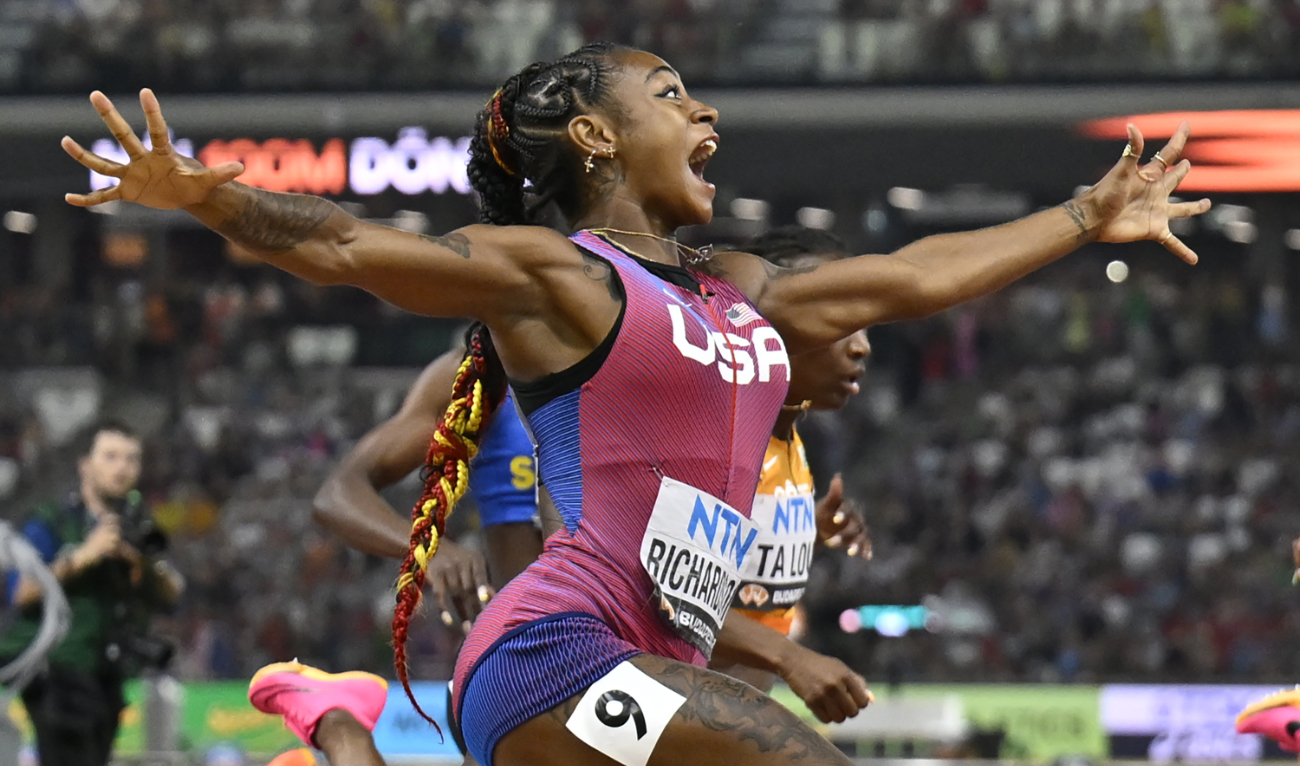 Sha'Carri Richardson, of the US, spreads her arms as he crosses the line to win gold in the women's 100 meter final during the World Athletics Championships in Budapest Monday. (AP)
