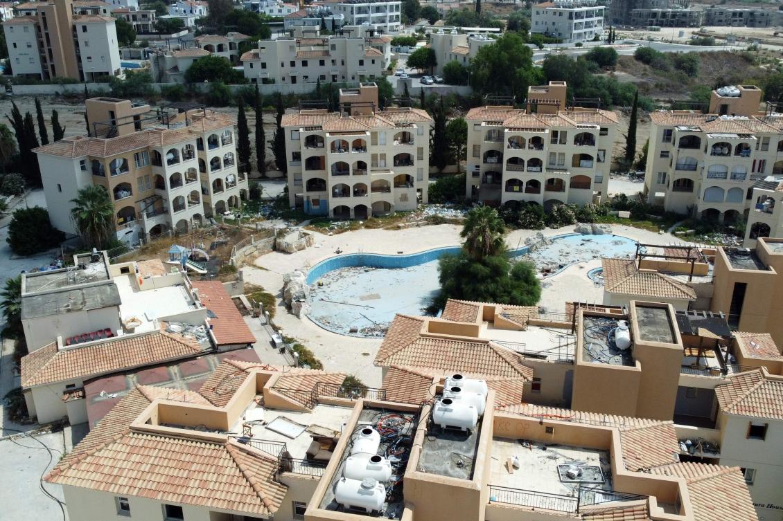 Cypriot authorities have started removing around 600 asylum seekers from the condemned apartment complex near the resort of Paphos after protests by residents. (AFP)