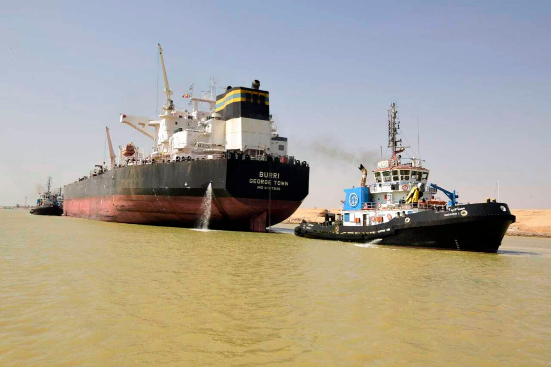 The Burri ship and a tugboat shown in the waterway after a collision with another large transport vessel. (AP)