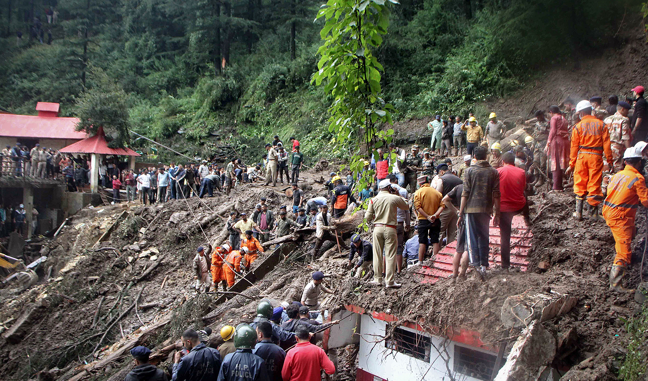 National Disaster Response Force (NDRF) personnel search for victims at the site of a landslide after a temple collapsed due to heavy rains in Shimla on August 14, 2023. (AFP)