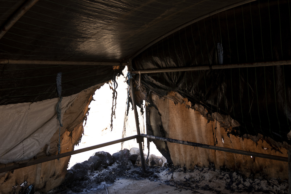 Above, a razed tent in the West Bank Palestinian Bedouin village of Al-Qabun after residents fleeing from Israeli settler violence burned most of the items they could not carry. (AP)