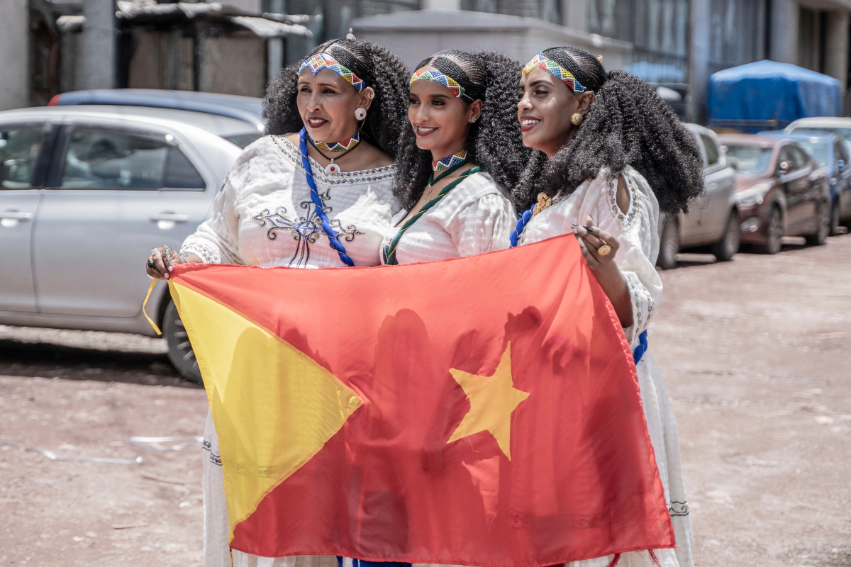 Women pose for a photograph while holding a Tigrayan flag during Ashenda festival in Addis Ababa, Ethiopia, on August 24, 2023. (AFP)