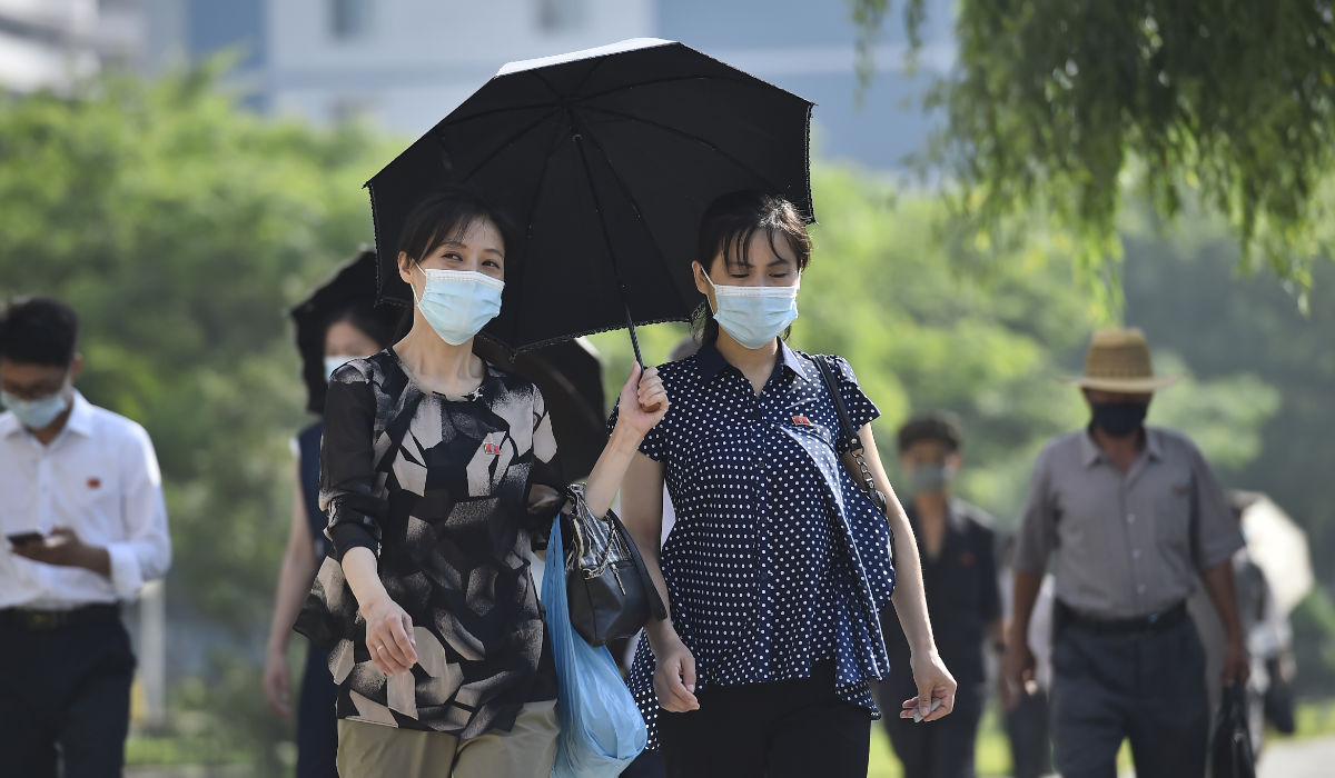 Pedestrians walk along Mirae Scientists' Street in Pyongyang on June 16, 2023. (AFP)