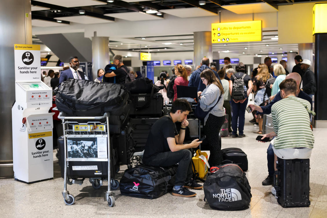 Travellers wait near the British Airways check-in area at Heathrow Airport, as Britain's National Air Traffic Service (NATS) restricts UK air traffic due to a technical issue causing delays, in London (REUTERS)