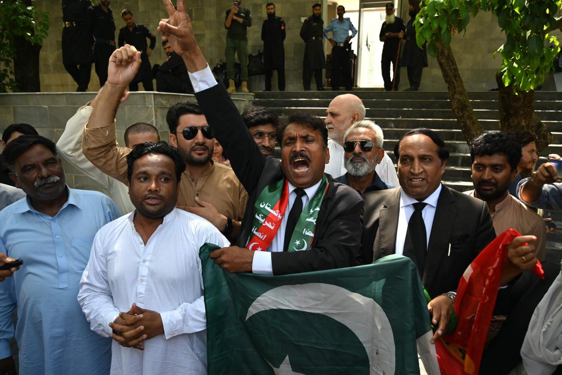 Lawyers and supporters of Pakistan's former Prime Minister Imran Khan, shout slogans as they celebrate outside the Islamabad High Court in Islamabad (AFP)